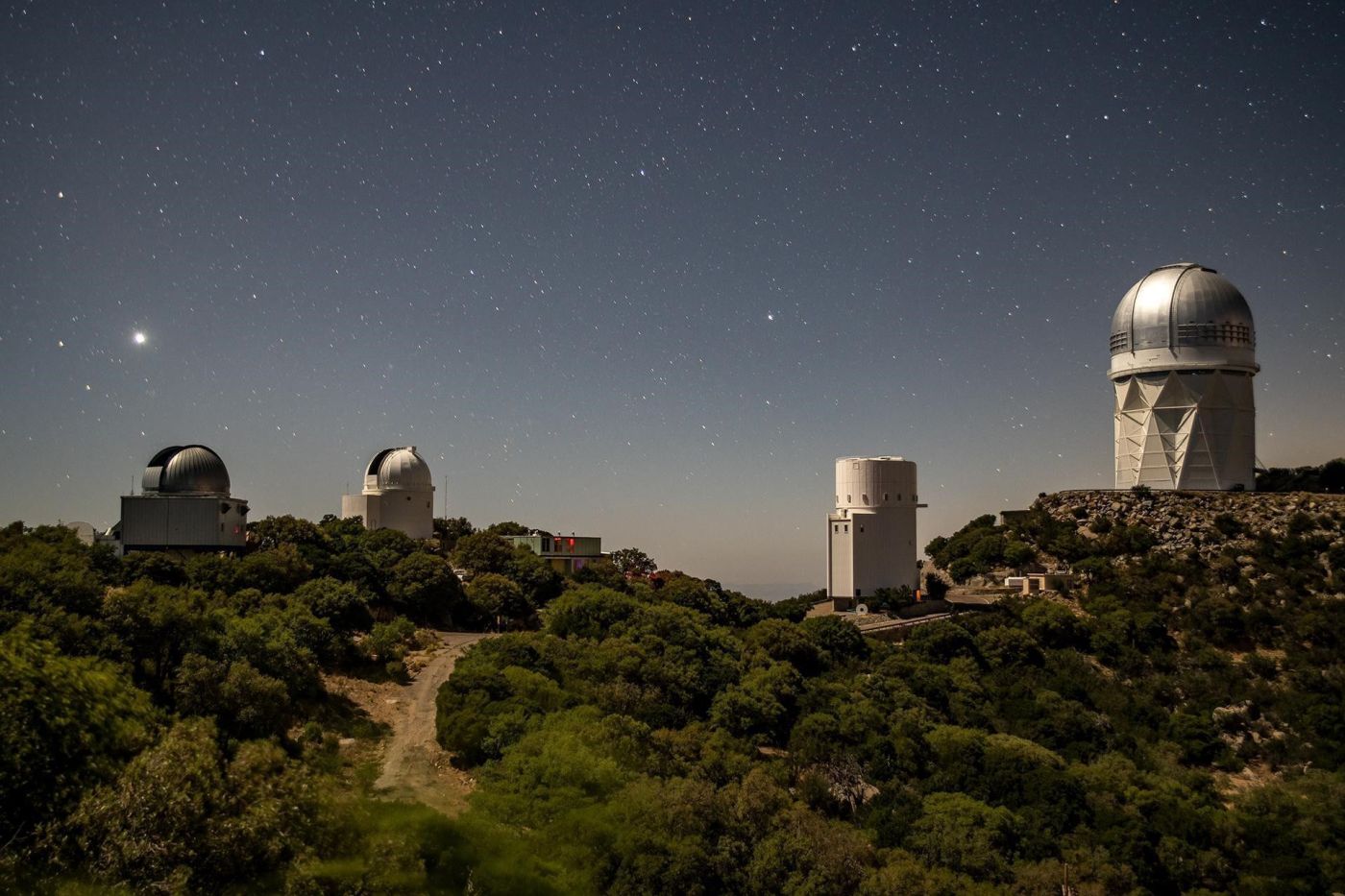 The Dark Energy Spectroscopic Instrument sits atop the Mayall 4-Meter Telescope at Kitt Peak National Observatory. DESI’s early data gathered in 2020 and 2021 is now publicly available. Credit: Marilyn Sargent/Berkeley Lab